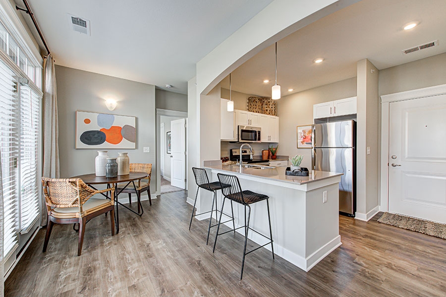 Dining area and kitchen in upscale apartment.