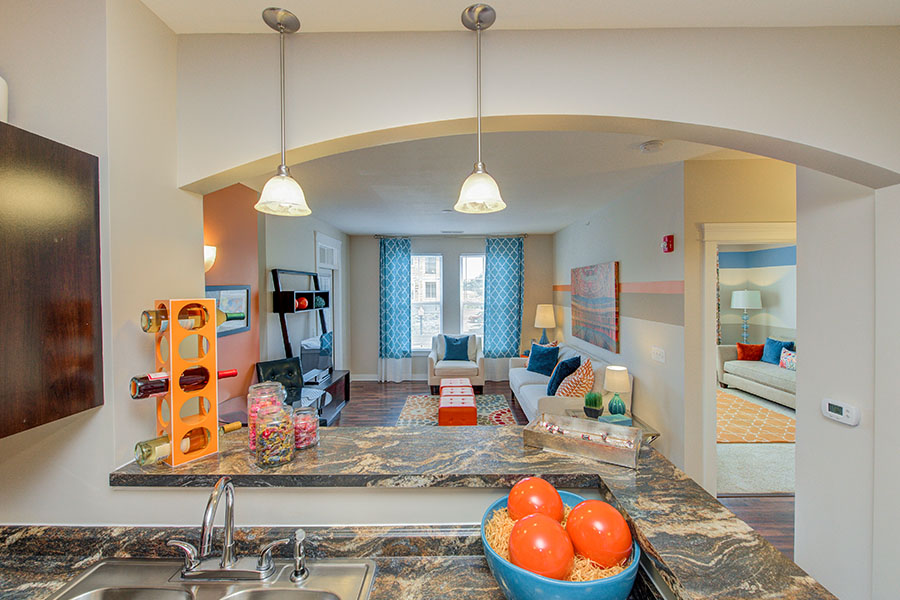 Any apartment lights like these at One One Six Apartments can become smart lights when you replace the bulbs with smart ones. Pendant lights hanging in a kitchen and living room at One One Six Apartments